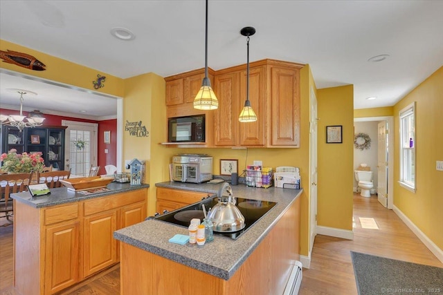 100 Adams Rd, Bloomfield, CT 06002 - kitchen featuring a peninsula, black appliances, and light wood-style floors