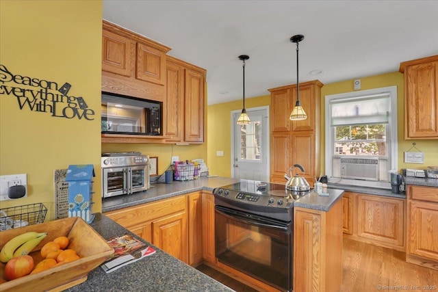 100 Adams Rd, Bloomfield, CT 06002 - kitchen with black appliances, cooling unit, pendant lighting, dark countertops, and a peninsula