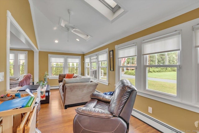 100 Adams Rd, Bloomfield, CT 06002 - living room featuring baseboard heating, ornamental molding, vaulted ceiling, a skylight, and ceiling fan