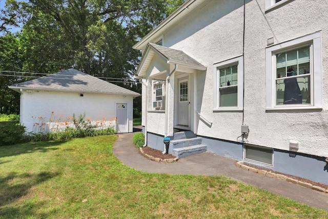 100 Adams Rd, Bloomfield, CT 06002 - view of side of home featuring entry steps, a lawn, stucco siding, and cooling unit