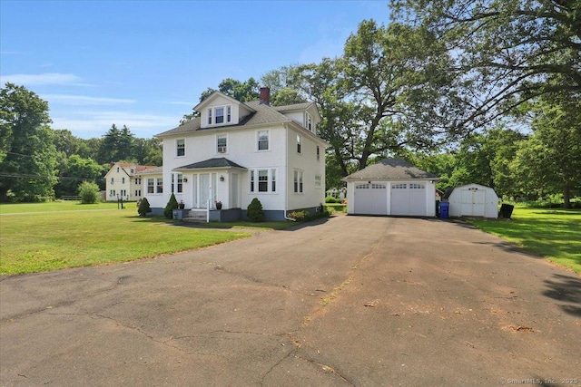 100 Adams Rd, Bloomfield, CT 06002 - view of front of property with a detached garage, a front lawn, a chimney, and a storage unit