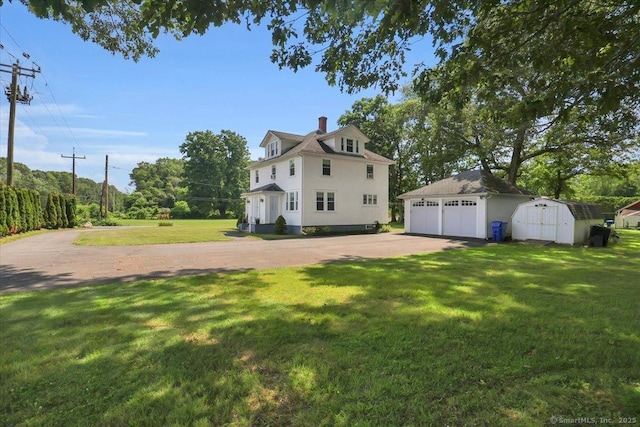 100 Adams Rd, Bloomfield, CT 06002 - view of property exterior featuring an outbuilding, a garage, a lawn, and a chimney