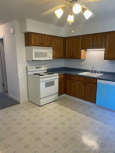 273 Derby Ave Unit 810, Derby, CT 06418 - kitchen featuring white appliances, light flooring, a ceiling fan, and brown cabinetry