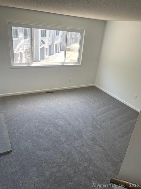 273 Derby Ave Unit 810, Derby, CT 06418 - unfurnished room with dark carpet and a textured ceiling