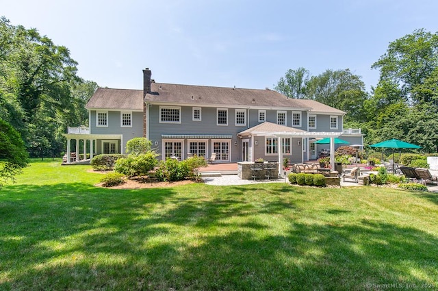 9 Tallwood Rd, Woodbridge, CT 06525 - rear view of property with an outdoor living space, a patio area, a chimney, a lawn, and a wooden deck