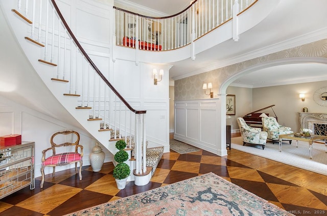 9 Tallwood Rd, Woodbridge, CT 06525 - foyer with a decorative wall, stairway, arched walkways, a towering ceiling, and ornamental molding