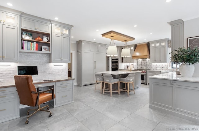 9 Tallwood Rd, Woodbridge, CT 06525 - kitchen with premium range hood, a breakfast bar, tasteful backsplash, gray cabinets, and recessed lighting