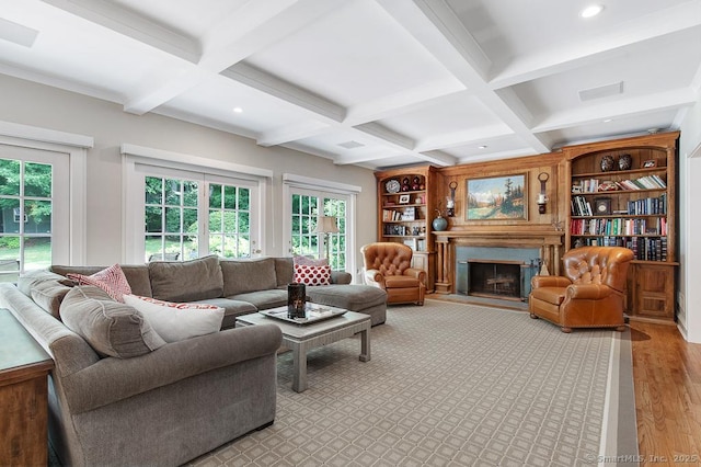 9 Tallwood Rd, Woodbridge, CT 06525 - living area featuring beam ceiling, coffered ceiling, healthy amount of natural light, wood finished floors, and a fireplace with raised hearth