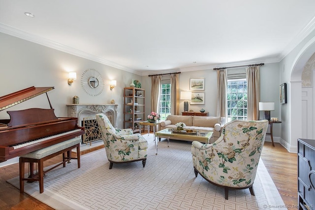 9 Tallwood Rd, Woodbridge, CT 06525 - living area with plenty of natural light, arched walkways, light wood-style floors, and ornamental molding