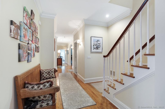 9 Tallwood Rd, Woodbridge, CT 06525 - hallway with ornamental molding, light wood-type flooring, stairway, and recessed lighting