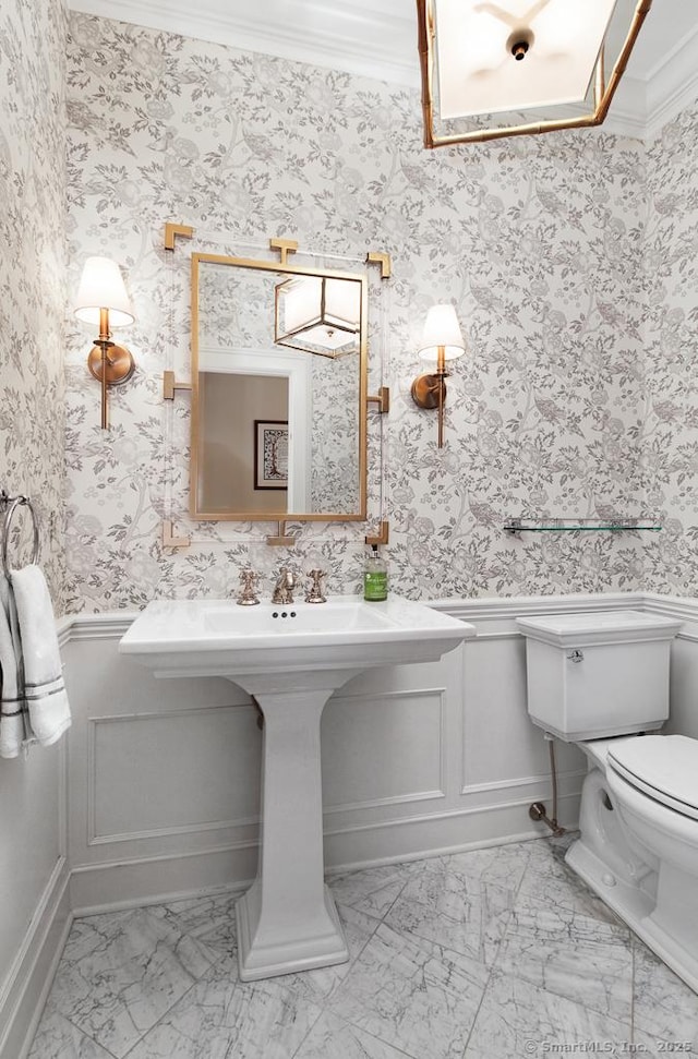 9 Tallwood Rd, Woodbridge, CT 06525 - half bathroom with marble look tiles, a wainscoted wall, crown molding, a decorative wall, and wallpapered walls