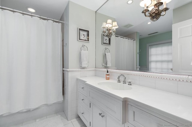 9 Tallwood Rd, Woodbridge, CT 06525 - full bathroom featuring a chandelier, vanity, recessed lighting, tile patterned flooring, and tile walls