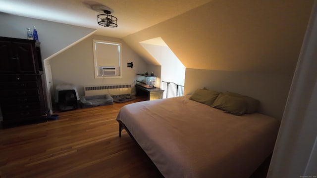 253 E Rd, East Windsor, CT 06016 - bedroom with radiator heating unit, cooling unit, wood finished floors, and lofted ceiling