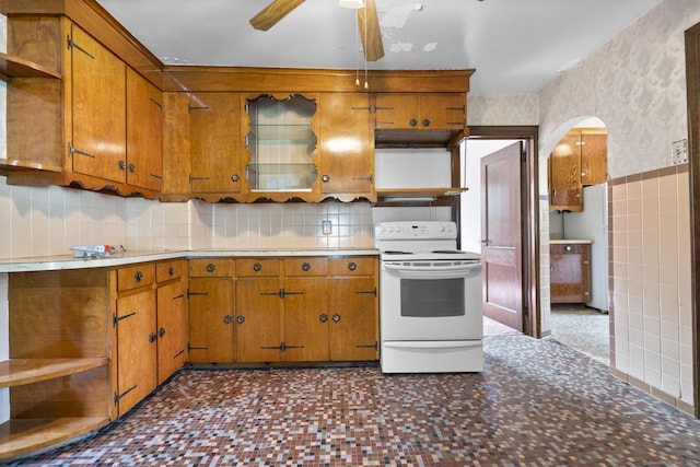 460 Stonybrook Rd, Stratford, CT 06614 - kitchen with open shelves, white electric range, arched walkways, ceiling fan, and brown cabinetry