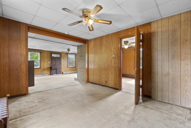 460 Stonybrook Rd, Stratford, CT 06614 - carpeted spare room featuring a ceiling fan, a drop ceiling, wooden walls, and a baseboard heating unit