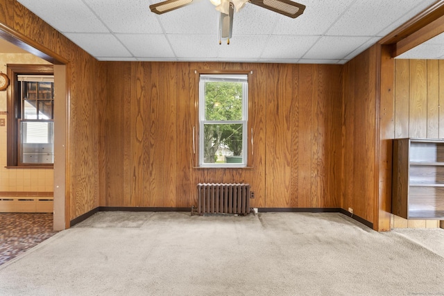 460 Stonybrook Rd, Stratford, CT 06614 - unfurnished room with radiator, a baseboard heating unit, wood walls, a paneled ceiling, and a ceiling fan