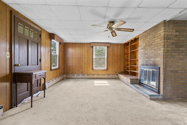 460 Stonybrook Rd, Stratford, CT 06614 - unfurnished living room featuring light colored carpet, a ceiling fan, a fireplace, built in features, and wooden walls