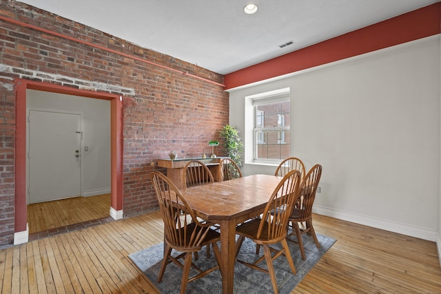 196 Crown St Unit 3J, New Haven, CT 06510 - dining area featuring light wood-type flooring and brick wall