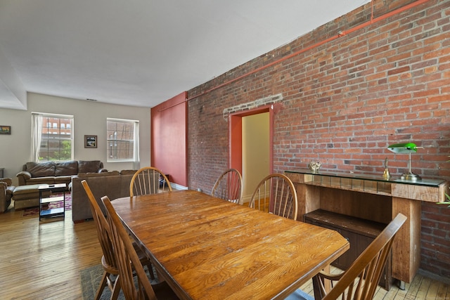 196 Crown St Unit 3J, New Haven, CT 06510 - dining area with wood-type flooring and brick wall