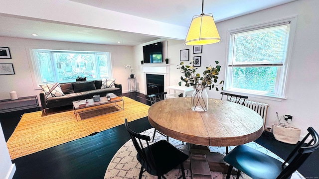671 Fairview Ave, Bridgeport, CT 06606 - dining area featuring a fireplace with flush hearth, wood finished floors, and recessed lighting