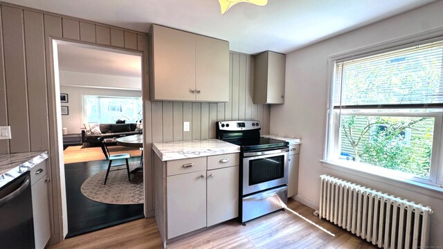 671 Fairview Ave, Bridgeport, CT 06606 - kitchen featuring stainless steel appliances, radiator, gray cabinetry, and plenty of natural light