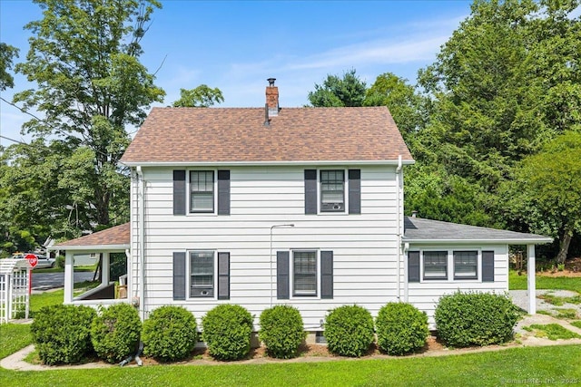 10 Gifford Ln, Norwich, CT 06389 - view of home's exterior featuring a chimney, roof with shingles, and a lawn