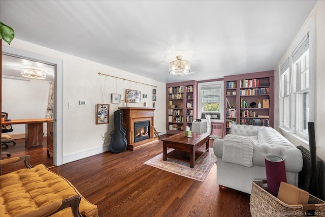 10 Gifford Ln, Norwich, CT 06389 - living area featuring wood finished floors, a chandelier, built in shelves, and a glass covered fireplace