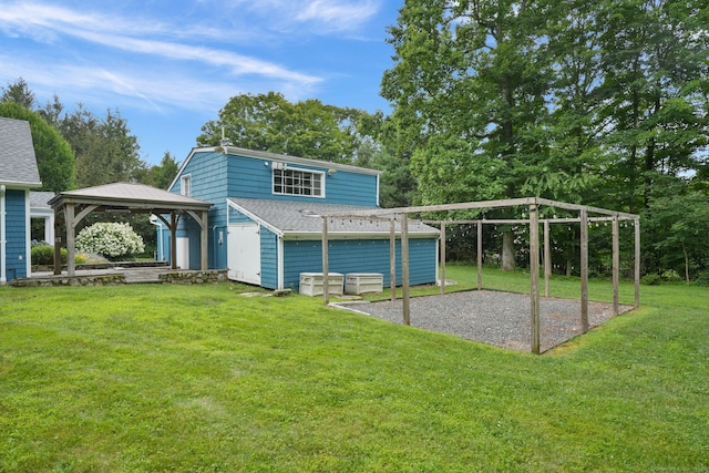 224 Fan Hill Rd, Monroe, CT 06468 - back of house featuring a gazebo, a carport, a lawn, gravel driveway, and an outbuilding