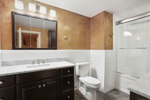 224 Fan Hill Rd, Monroe, CT 06468 - bathroom featuring vanity, tile walls, tile patterned floors, shower / bath combination with glass door, and a wainscoted wall