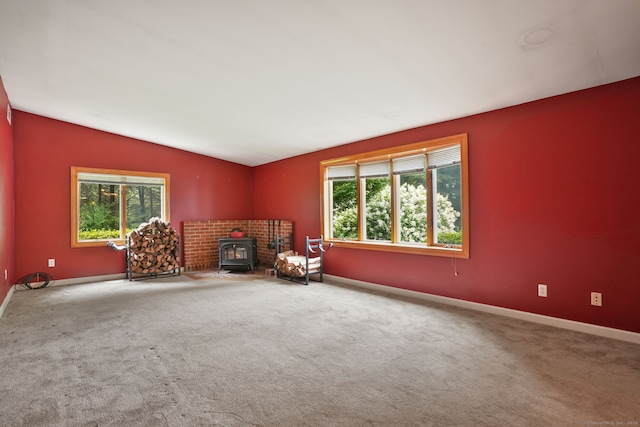 224 Fan Hill Rd, Monroe, CT 06468 - unfurnished room with a wood stove, vaulted ceiling, and carpet floors