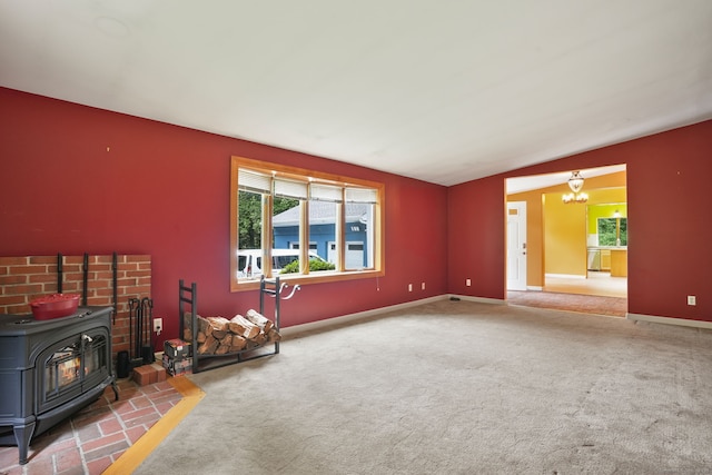 224 Fan Hill Rd, Monroe, CT 06468 - living room with a wood stove, carpet flooring, a chandelier, and vaulted ceiling