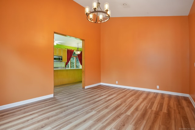 224 Fan Hill Rd, Monroe, CT 06468 - spare room featuring light wood-style flooring, a chandelier, and a high ceiling