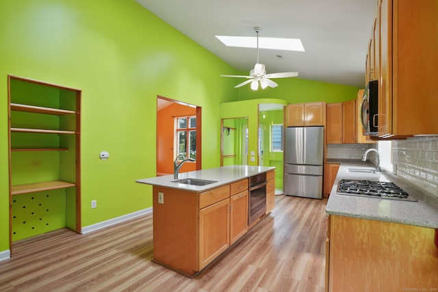 224 Fan Hill Rd, Monroe, CT 06468 - kitchen featuring stainless steel appliances, lofted ceiling, light wood finished floors, a skylight, and a center island with sink