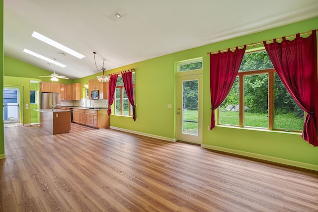 224 Fan Hill Rd, Monroe, CT 06468 - kitchen with stainless steel appliances, lofted ceiling, light wood-style floors, a skylight, and a kitchen island with sink