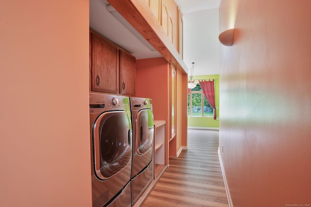 224 Fan Hill Rd, Monroe, CT 06468 - laundry area with washer and dryer, cabinet space, and light wood-type flooring