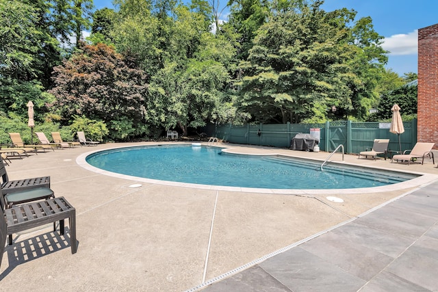 6 Hills Ln Unit 6, Norwalk, CT 06880 - community pool with a patio and view of wooded area