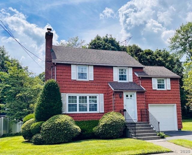 84 Blamey Cir, Stratford, CT 06614 - view of front of property featuring a chimney, a garage, and a front lawn