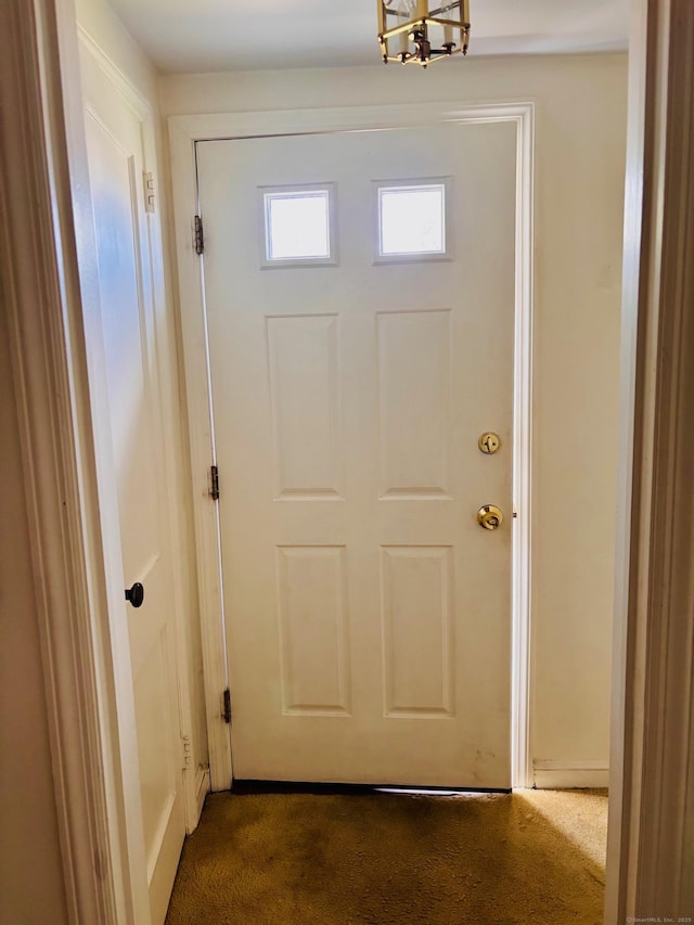 84 Blamey Cir, Stratford, CT 06614 - doorway to outside with a chandelier and dark colored carpet