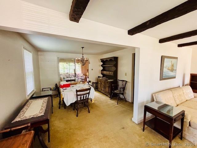 84 Blamey Cir, Stratford, CT 06614 - dining space featuring a chandelier, beam ceiling, and light colored carpet