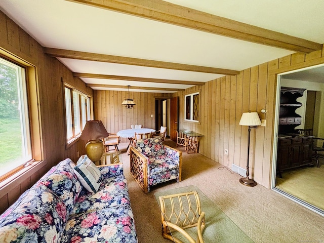 84 Blamey Cir, Stratford, CT 06614 - carpeted living room with beam ceiling, wood walls, and healthy amount of natural light