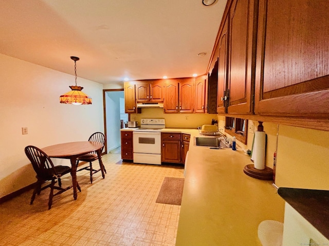 84 Blamey Cir, Stratford, CT 06614 - kitchen with electric range, light countertops, under cabinet range hood, brown cabinetry, and pendant lighting