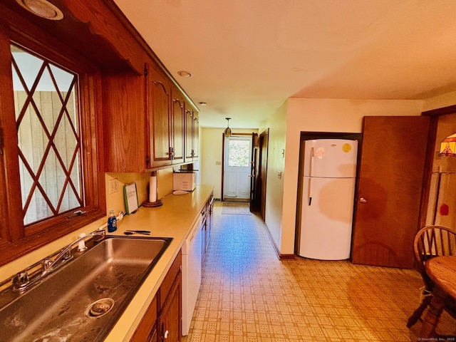 84 Blamey Cir, Stratford, CT 06614 - kitchen with white appliances, light floors, brown cabinets, and light countertops
