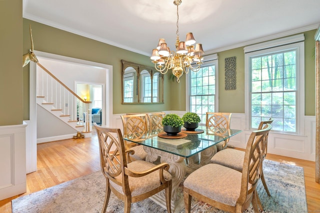 80 Jeremiahs Way, Glastonbury, CT 06073 - dining space with wainscoting, stairs, a chandelier, light wood finished floors, and crown molding
