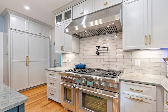 80 Jeremiahs Way, Glastonbury, CT 06073 - kitchen featuring under cabinet range hood, high quality appliances, glass insert cabinets, light stone countertops, and recessed lighting