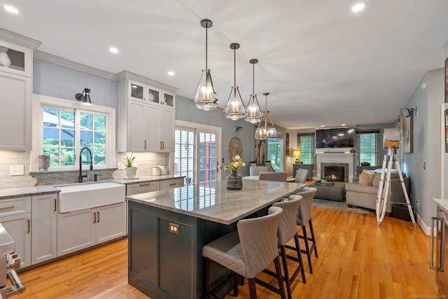 80 Jeremiahs Way, Glastonbury, CT 06073 - kitchen with open floor plan, decorative backsplash, light stone counters, light wood-style flooring, and recessed lighting
