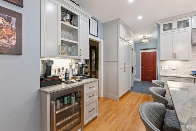 80 Jeremiahs Way, Glastonbury, CT 06073 - indoor dry bar featuring beverage cooler, decorative backsplash, recessed lighting, and light wood-type flooring