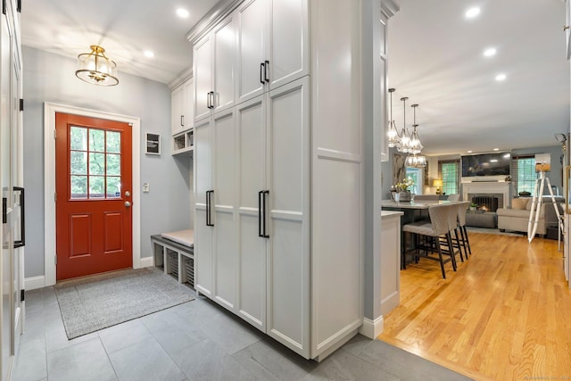 80 Jeremiahs Way, Glastonbury, CT 06073 - mudroom with plenty of natural light, a chandelier, recessed lighting, and a warm lit fireplace