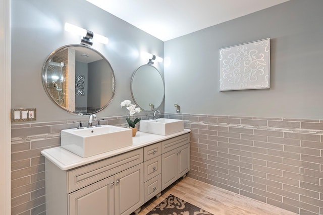 80 Jeremiahs Way, Glastonbury, CT 06073 - full bathroom featuring tile walls, double vanity, a wainscoted wall, and wood finished floors