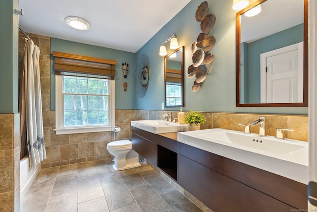 80 Jeremiahs Way, Glastonbury, CT 06073 - full bath with tile walls, healthy amount of natural light, double vanity, shower / bathtub combination with curtain, and a wainscoted wall