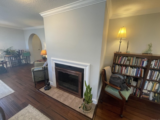 500 Prospect St Apt 4A, New Haven, CT 06511 - living area featuring wood finished floors, arched walkways, a fireplace with flush hearth, ornamental molding, and a textured ceiling